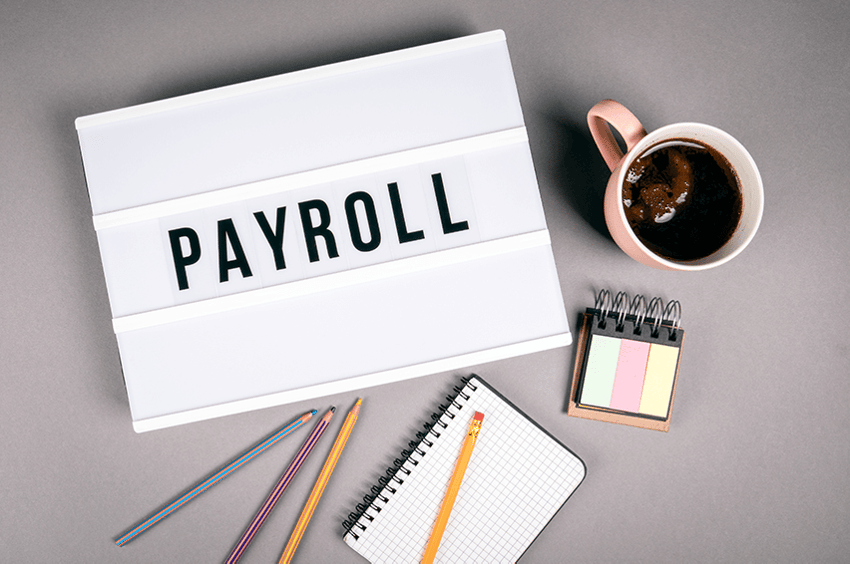 payroll-sign-coffee-pen-paper-desk